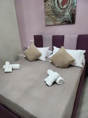 a bed with towels and pillows on it at Kalaciuri Rooms in Palermo