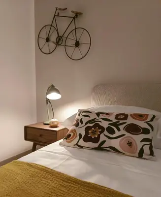 a bedroom with a bed with a bike hanging on the wall at SulCorsoRooms in Palermo