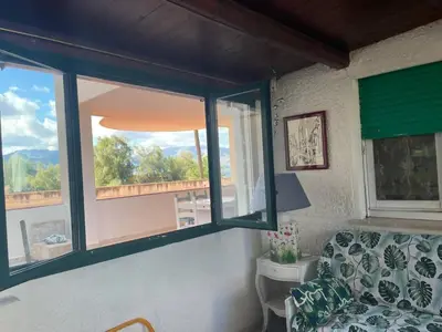 a living room with a couch and a window at Casa del Sorriso in Isola delle Femmine