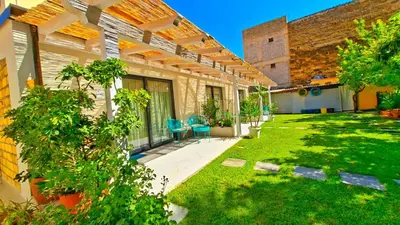 an outdoor patio with chairs and a yard at Casetta Giardinetto in Altavilla Milicia