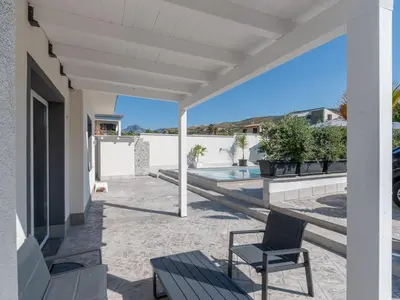 a patio with a table and a chair on a house at Luxury Villa Sicula Trabia in Trabia
