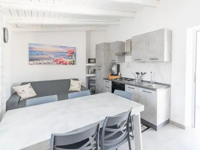 a kitchen and dining room with a table and chairs at Luxury Villa Sicula Trabia in Trabia
