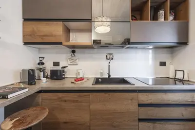 a kitchen with wooden cabinets and a sink at Mama apt - Comfort & style in Partanna Mondello in Palermo
