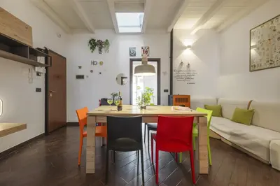 a dining room and living room with a table and chairs at Mama apt - Comfort & style in Partanna Mondello in Palermo