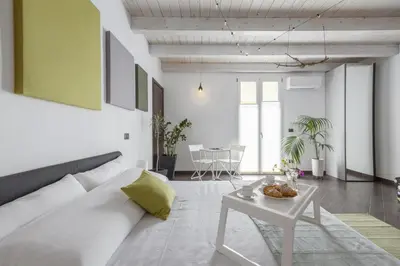 a living room with a white couch and a table at Mama apt - Comfort & style in Partanna Mondello in Palermo