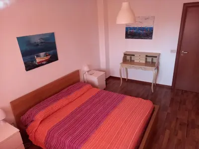 a small bedroom with a bed and a table at Apartment in Villa a Mondello in Mondello