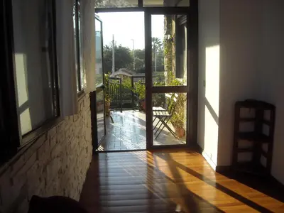 a hallway with an open door to a patio at Apartment in Villa a Mondello in Mondello