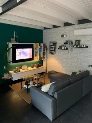 a living room with a couch and a flat screen tv at Dimora Stella Boutique in Alcamo