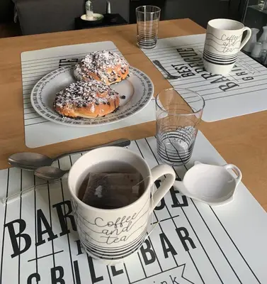 a table with two donuts and a cup of coffee at Dimora Stella Boutique in Alcamo