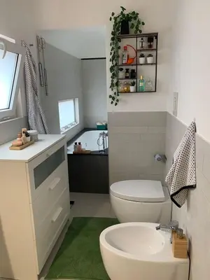 a bathroom with a white toilet and a sink at Dimora Stella Boutique in Alcamo