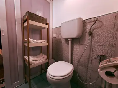 a small bathroom with a toilet and a sink at La Casetta del Centro in Palermo