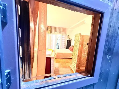 a view of a room through a glass door at La Casetta del Centro in Palermo