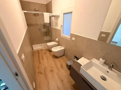 a bathroom with a toilet and a sink at Dimora Santa Spina - La Terrazza in Palermo