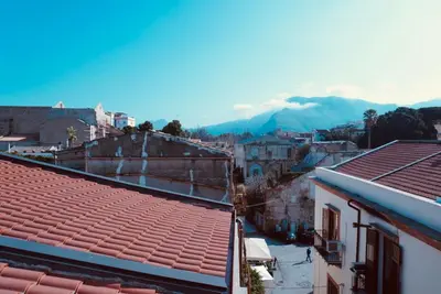 a view of a city with mountains in the background at Epic terrace in Kalsa in Palermo