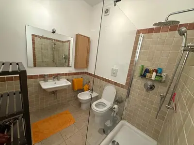 a bathroom with a toilet and a sink and a shower at Epic terrace in Kalsa in Palermo