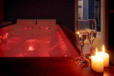 a hot tub with two glasses of wine and candles at Valenza Exclusive Suites & Rooms in Palermo