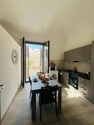 a kitchen with a table and a dining room at AL CAPO casa vacanze in Palermo
