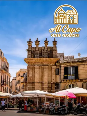 a building with umbrellas in front of a market at AL CAPO casa vacanze in Palermo