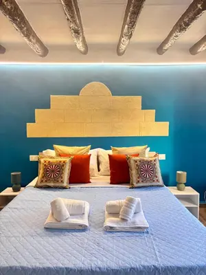 a bedroom with a bed with two towels on it at Dimora Albanese in Palermo