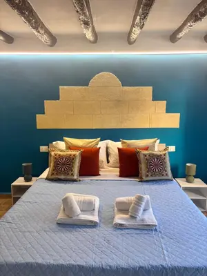 a bedroom with a bed with two towels on it at Dimora Albanese in Palermo