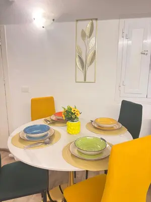 a dining room table with chairs and plates on it at Dimora Albanese in Palermo