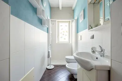 a bathroom with a white sink and a toilet at nonMama - Comfort & charm in Partanna Mondello in Palermo