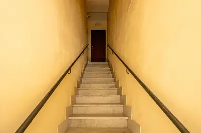 a hallway with stairs in a building with a door at nonMama - Comfort & charm in Partanna Mondello in Palermo