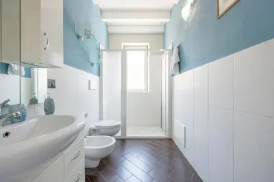 a bathroom with a white sink and a toilet at nonMama - Comfort & charm in Partanna Mondello in Palermo