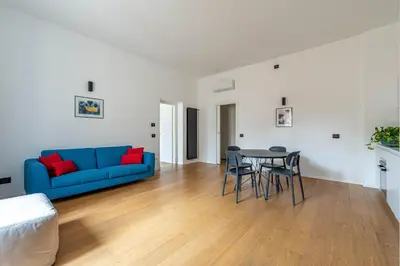 a living room with a blue couch and a table at Bellini Apartment by Wonderful Italy in Palermo
