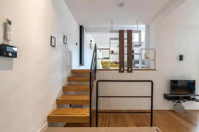a staircase in a home with white walls and wooden floors at Bellini Apartment by Wonderful Italy in Palermo