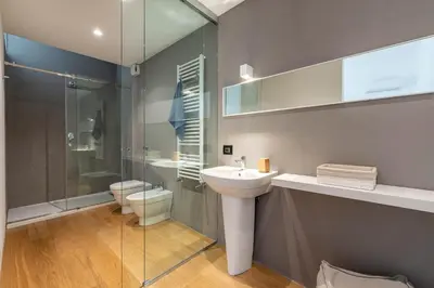 a bathroom with a sink and a toilet and a shower at Bellini Apartment by Wonderful Italy in Palermo