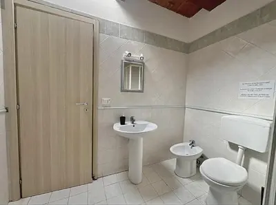 a bathroom with a toilet and a sink at Appartamento politeama Palermo in Palermo