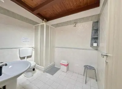 a bathroom with a toilet and a sink and a stool at Appartamento politeama Palermo in Palermo
