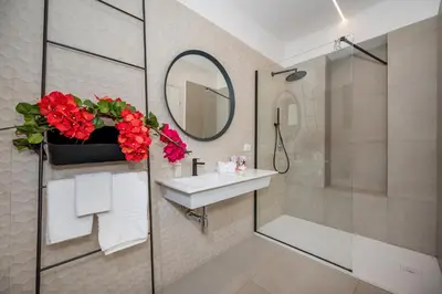 a bathroom with a sink and a shower and a mirror at Villa Maria con piscina e vista mare 12 posti letto in Castellammare del Golfo