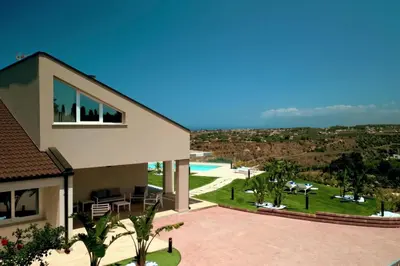 a house with a view of a pool at Villa Aversa by PosarelliVillas in Castellammare del Golfo