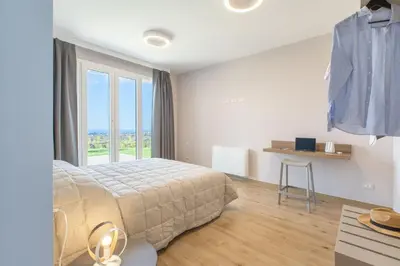 a bedroom with a bed and a large window at Villa Aversa by PosarelliVillas in Castellammare del Golfo