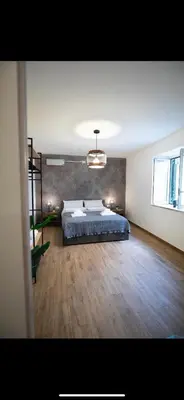 a large bedroom with a bed and a wooden floor at Duomo View Apartment in Monreale
