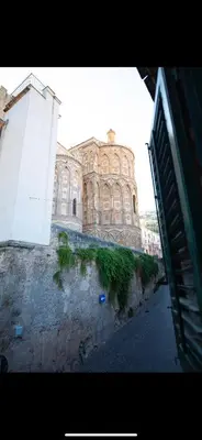 a large building sitting on top of a street at Duomo View Apartment in Monreale