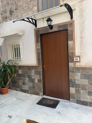a brown door on a building with a mirror at Casa AG in Palermo