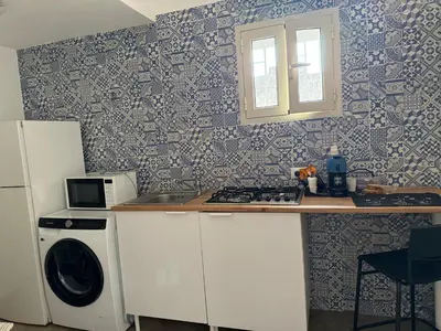 a kitchen with a sink and a stove and a washer at Casa AG in Palermo