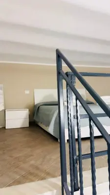 a bedroom with a bed and a black railing at Casa AG in Palermo