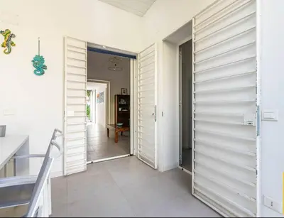 a hallway with white wooden walls and a door at Abracadabra Hidden Garden in Palermo