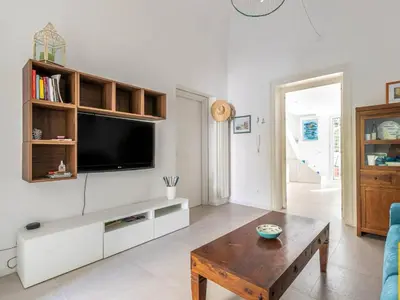 a living room with a tv and a coffee table at Abracadabra Hidden Garden in Palermo