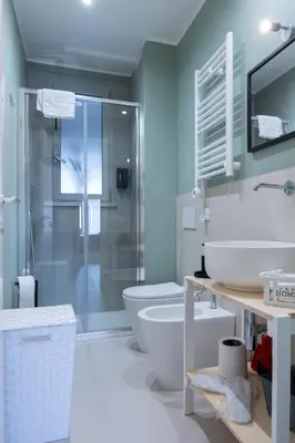 a bathroom with a toilet and a sink and a shower at Duecento Rooms in Palermo