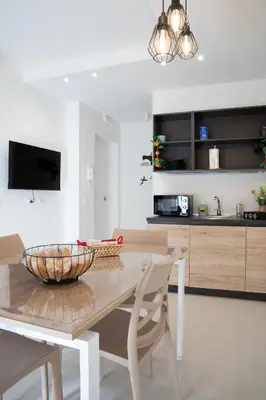 a kitchen with a wooden table with a bowl on it at Duecento Rooms in Palermo