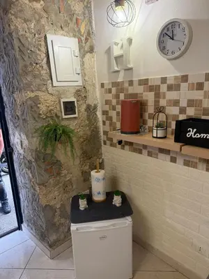a bathroom with a toilet and a clock on the wall at Casa Bastiano in Palermo