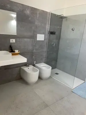 a bathroom with a toilet and a sink and a shower at Mdue in Palermo
