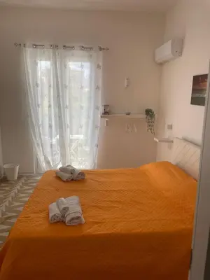a bedroom with a bed with two towels on it at Mdue in Palermo