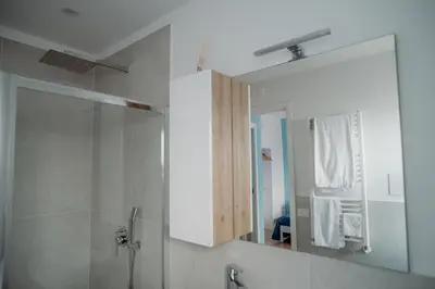 a bathroom with a shower and a mirror at Sarina's apartment in Palermo