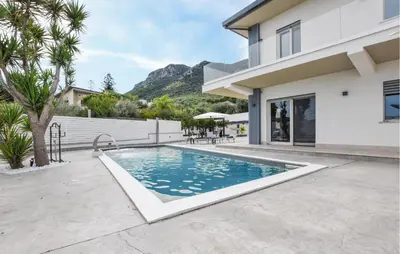 a swimming pool in the backyard of a house at Amazing Home In Trabia in Trabia